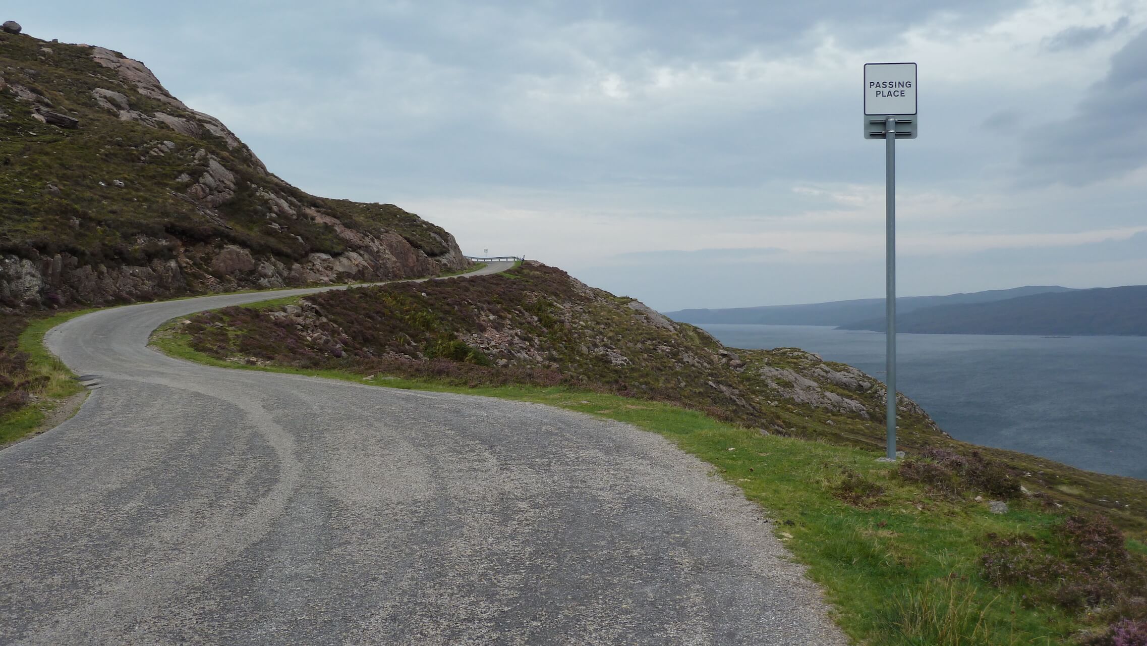 Winding blind corner bend in the road along Loch Torridon, Applecross Peninsula