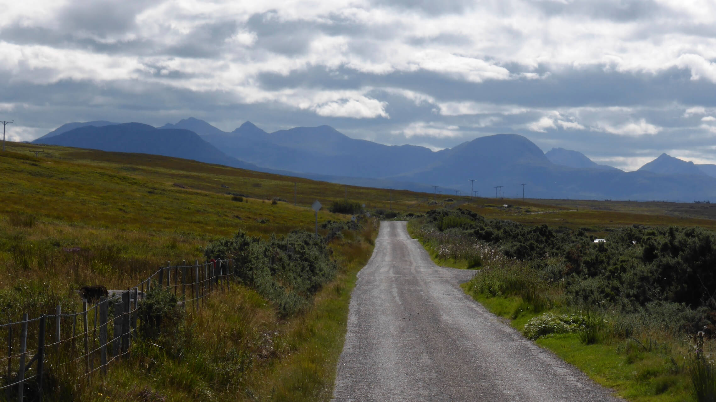 Single track road with Torridon mountains in the distance