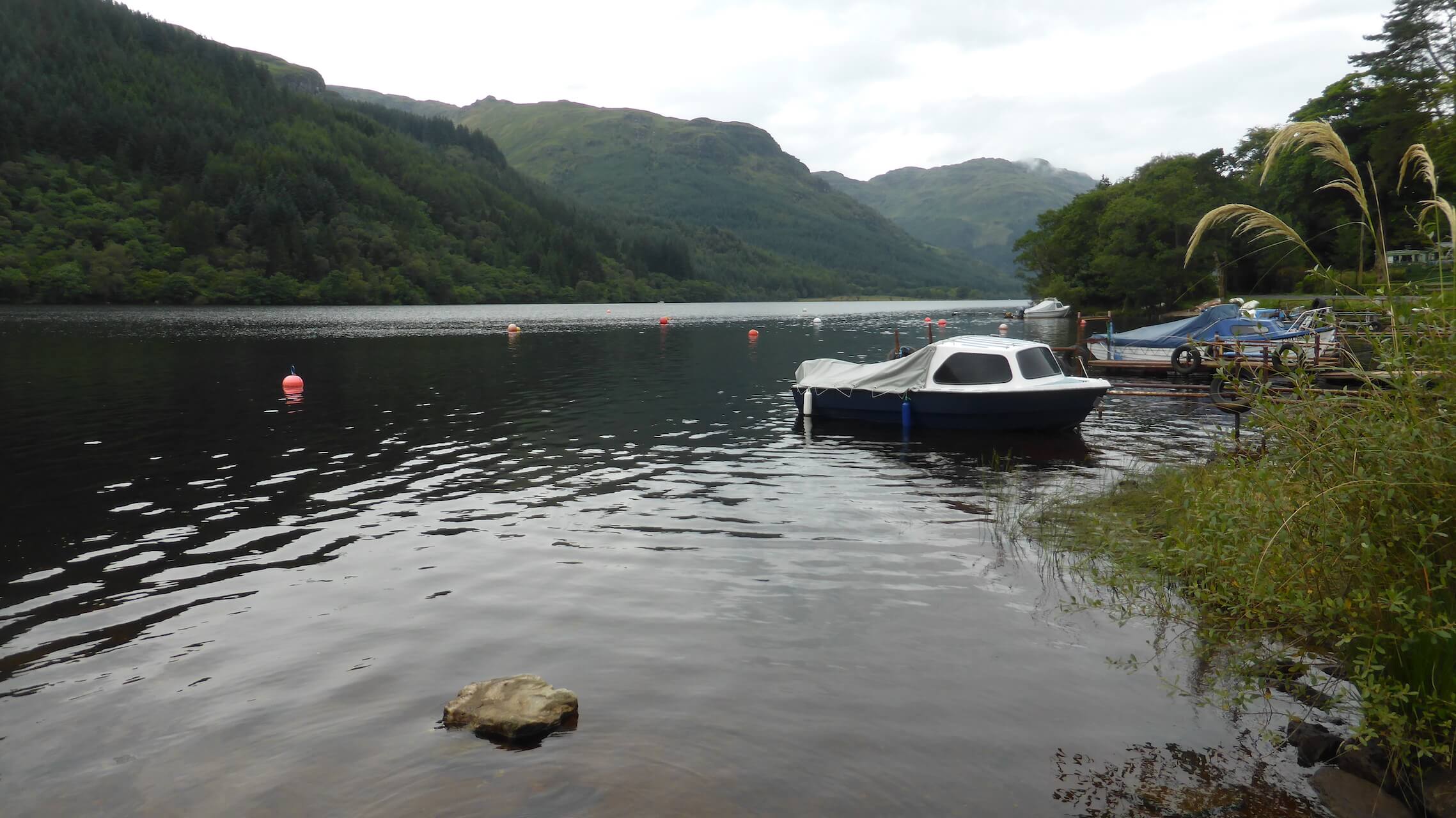 Small boat on the quiet shore of Loch Eck