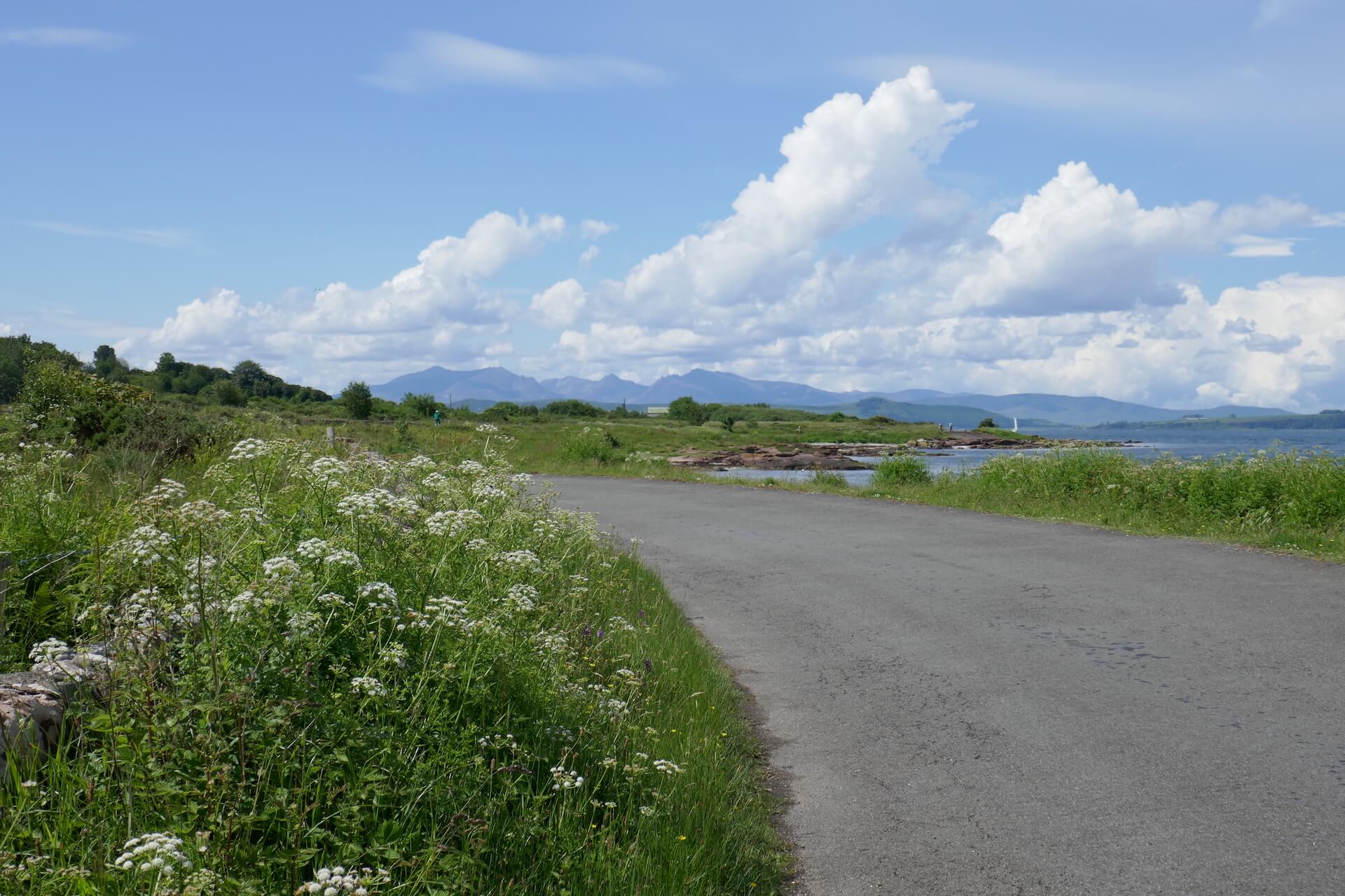Cumbrae coastal road with view of the mountains of Arran in the distance