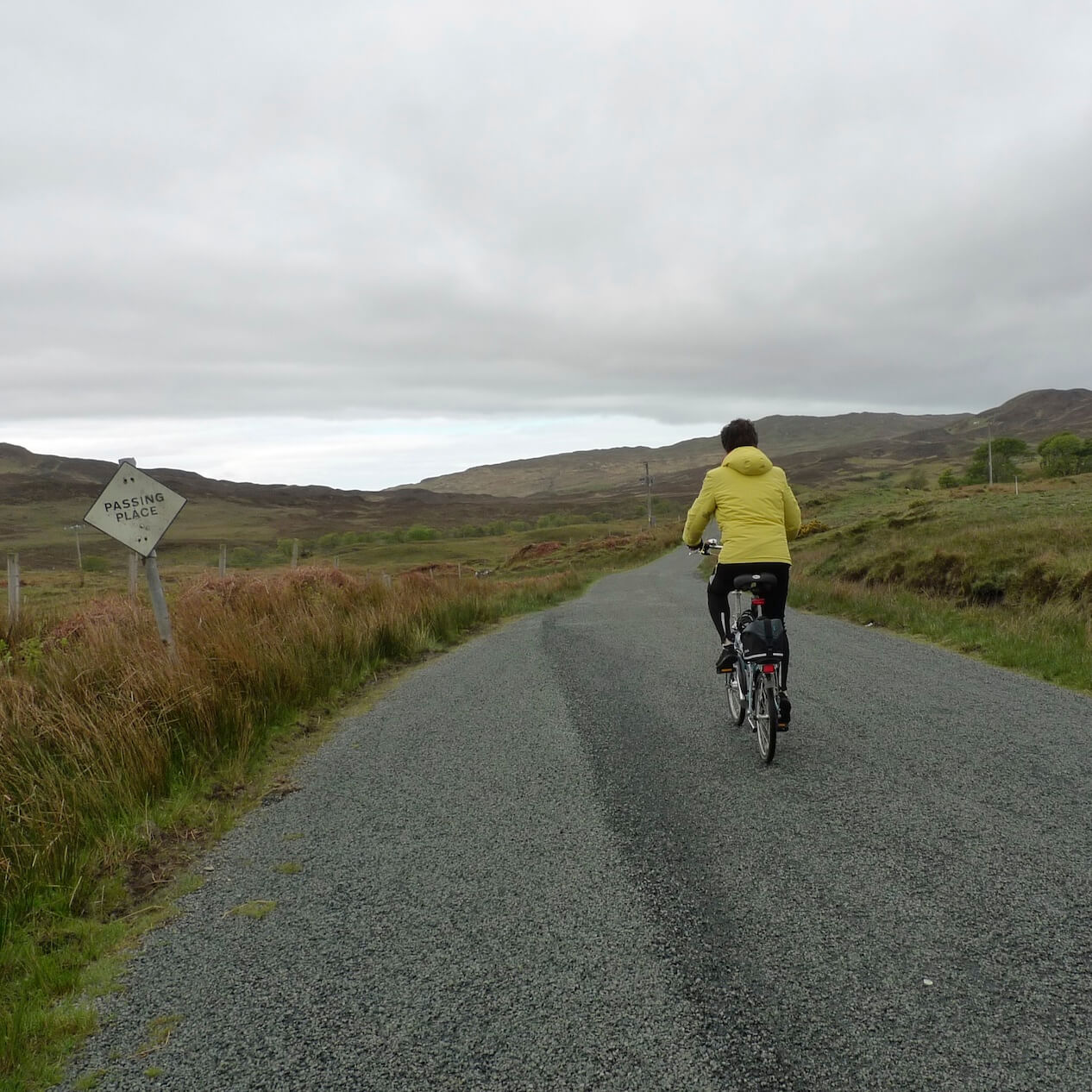 A cyclist ascends a single track road heading overland from Kilbeg, Sleat Peninsula, Skye