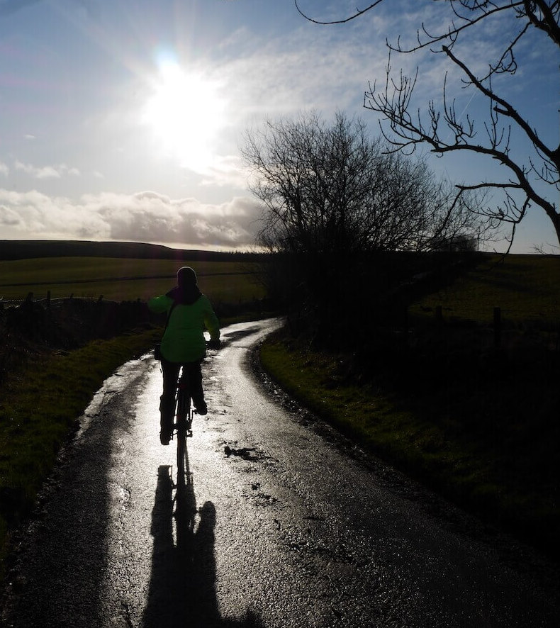 A cyclist on the single track road near Loch Coulter near Stirling